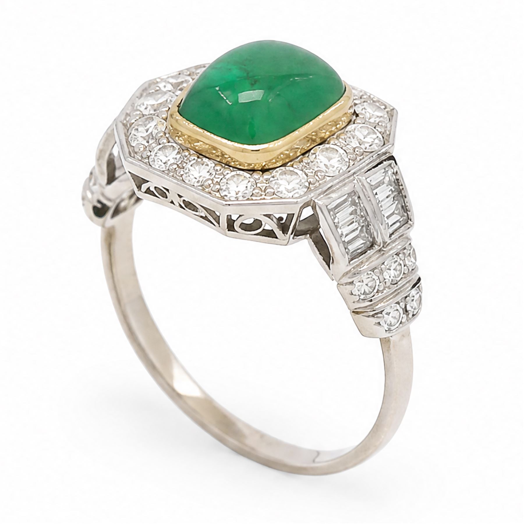18ct white gold and platinum emerald and diamond cluster ring, single octagonal cabochon cut emerald, surrounded by sixteen milgrain set round cut diamonds, the shoulders set with baguette and single cut diamonds, stamped 18ct, total diamond weight approx 1.55 carat