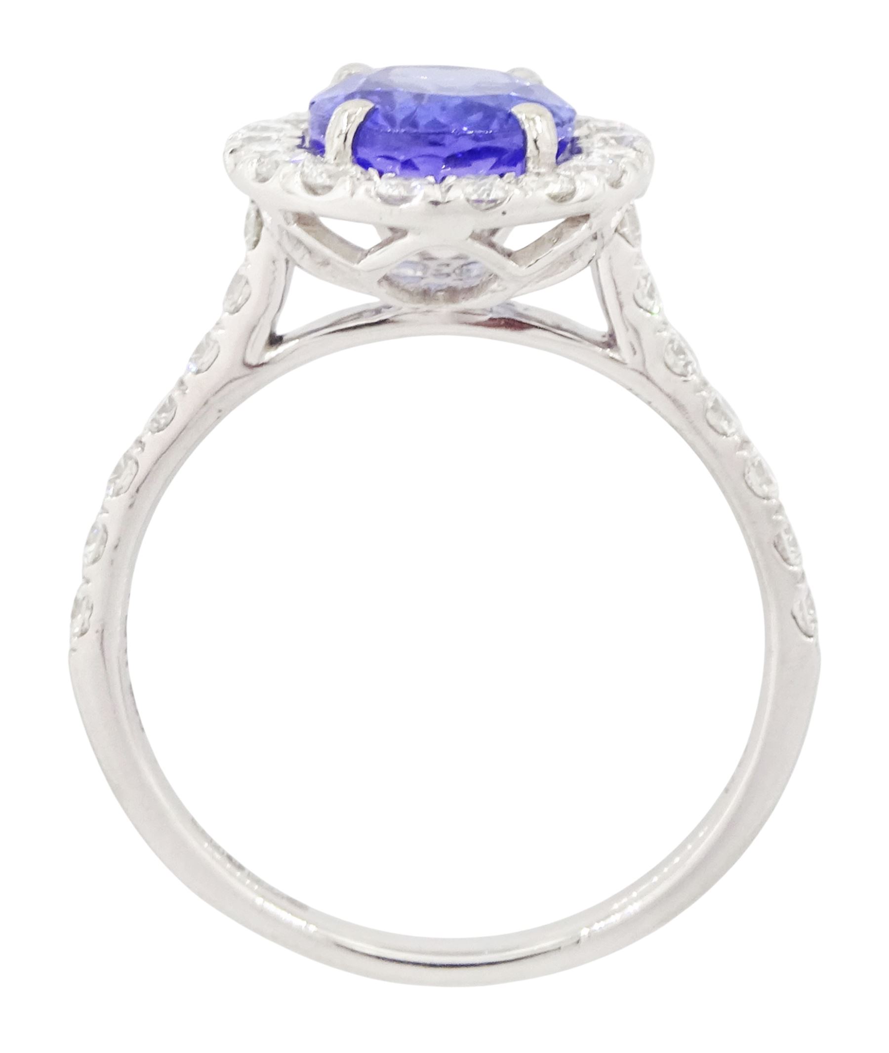 Platinum tanzanite and diamond cluster ring, single oval tanzanite of 2.36 carat, with round brilliant cut diamond surround and diamond set shoulders, hallmarked, total diamond weight 0.76 carat, with World Gemological Institute report