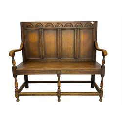 19th century oak settle, lunette carved cresting rail over quadruple panelled back, plank seat, on turned supports joined by stretchers
