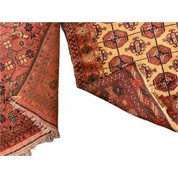 Old Afghan red ground rug, decorated with repeating bird motifs, the guarded border with candelabra pattern (150cm x 104cm); and antique Afghan burnt orange ground rug, field decorated with octagonal lozenges, repeating geometric border (134cm x 95cm) (2)