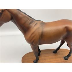 Beswick 'Mill Reef' horse figure, on a wooden plinth together with Beswick Ware horse figure 'Red Rum' on wood plinth, both with printed mark beneath