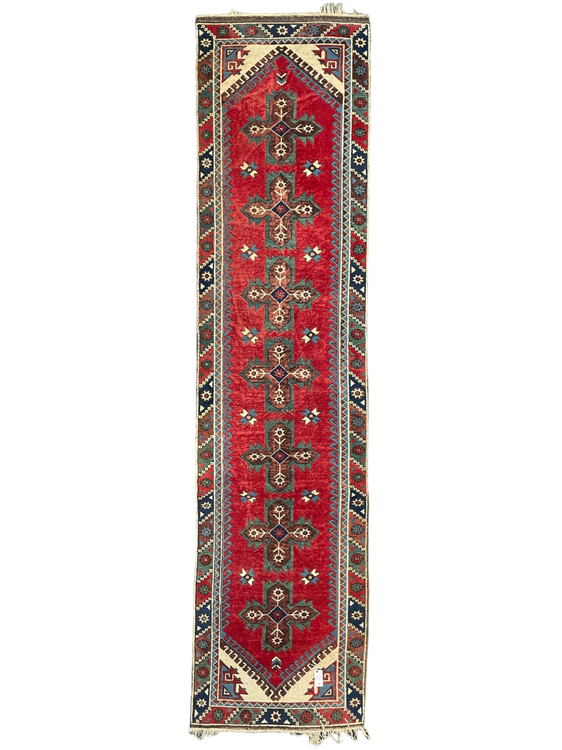 Turkish red ground runner, seven star and leaf decorated medallions, geometric design repeating border
