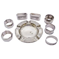 Early 20th century silver ashtray, of circular form with reed and ribbon edge, hallmarked William Hutton & Sons Ltd, Sheffield 1918, together with seven silver napkin rings, comprising pair of 1930's octagonal form examples, hallmarked E F Braham Ltd, Birmingham 1939, a further pair of 1930's examples of compressed oval form, hallmarked E F Braham Ltd, Birmingham 1939, and three others, various hallmarks, dated 1905, 1924, and 1935, approximate total weight 8.80 ozt (274 grams)