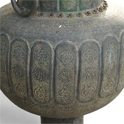 Pair of large Indian cast metal garden urns, each of bulbous form with engraved foliate and script panels, twin ring handles to the neck, raised on fluted pedestal bases