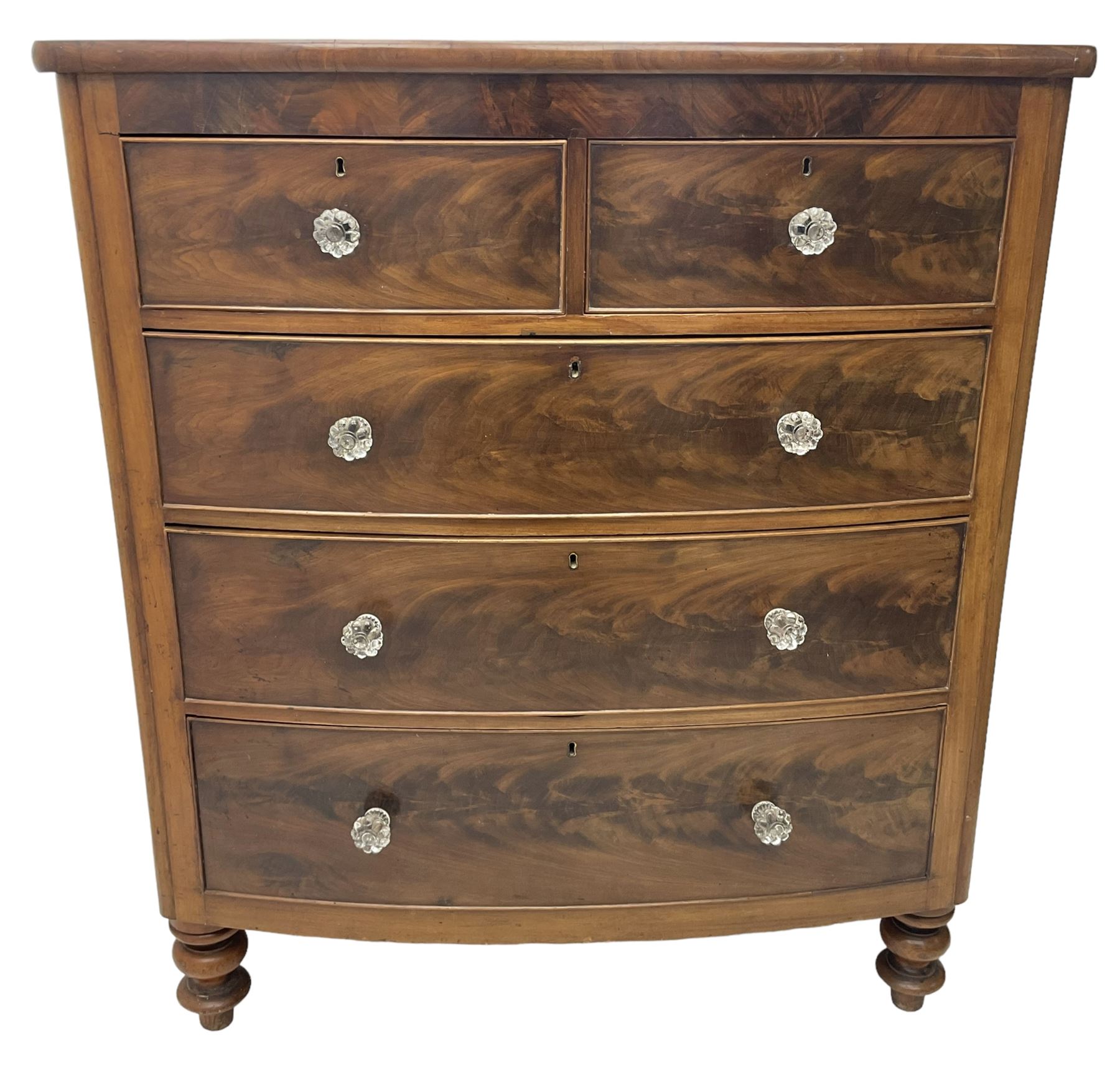 Victorian mahogany bow front chest, fitted with two short over three long graduating cock-beaded drawers, each with glass handles, raised on turned feet