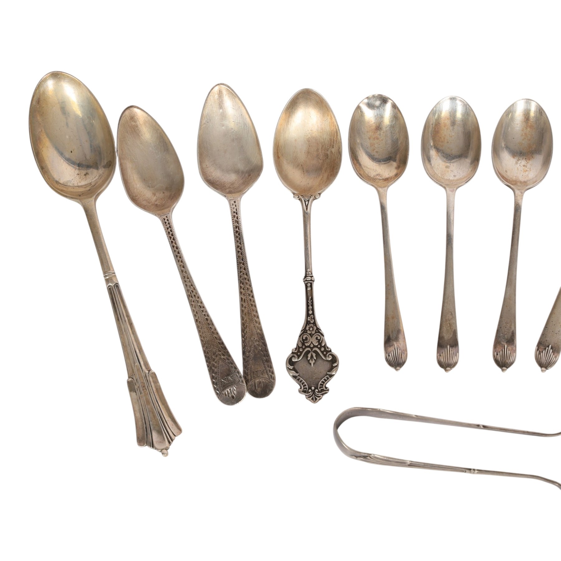 Collection of silver cutlery, including sugar tongs, coffee bean spoons, teaspoons, etc, all hallmarked