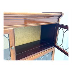 Early 20th century Globe Wernicke design stacking walnut bookcase, fitted with four sections each with two leaded glass doors, raised on turned feet