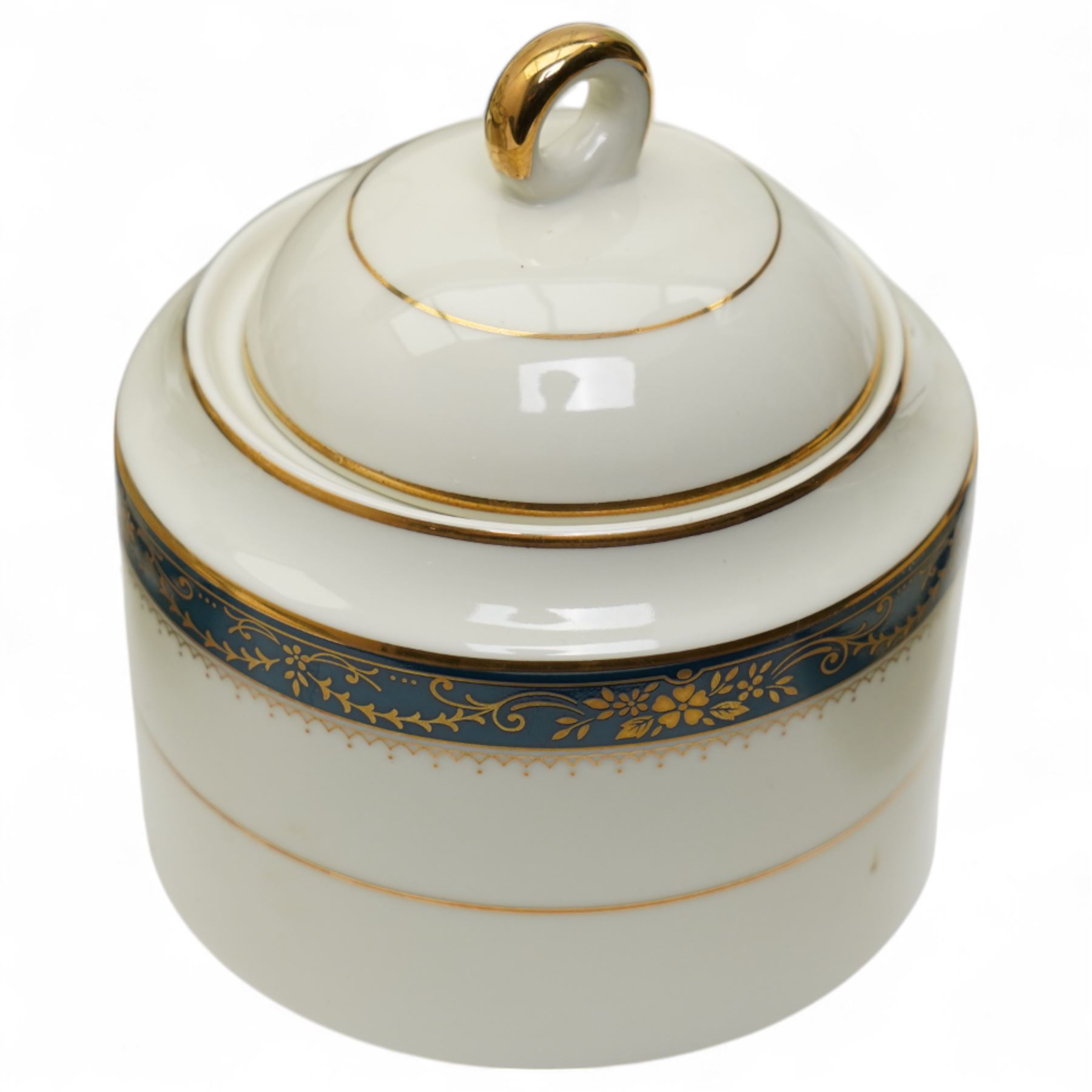 Japanese tea and dinner service retailed by Gazzaz, decorated with blue boarders and heightened with gilt foliate motifs, comprising eight teacups, eight saucers, coffee pot, sucrier, milk jug, eight cake plates, eight soup bowls, eight dinner plates etc