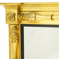 Early 19th century Regency giltwood and gesso overmantel mirror, rectangular plate within a black inner border, form with stepped cornice above a frieze carved with shell and foliate motifs, flanked by swell turned fluted pilasters with applied anthemion decoration