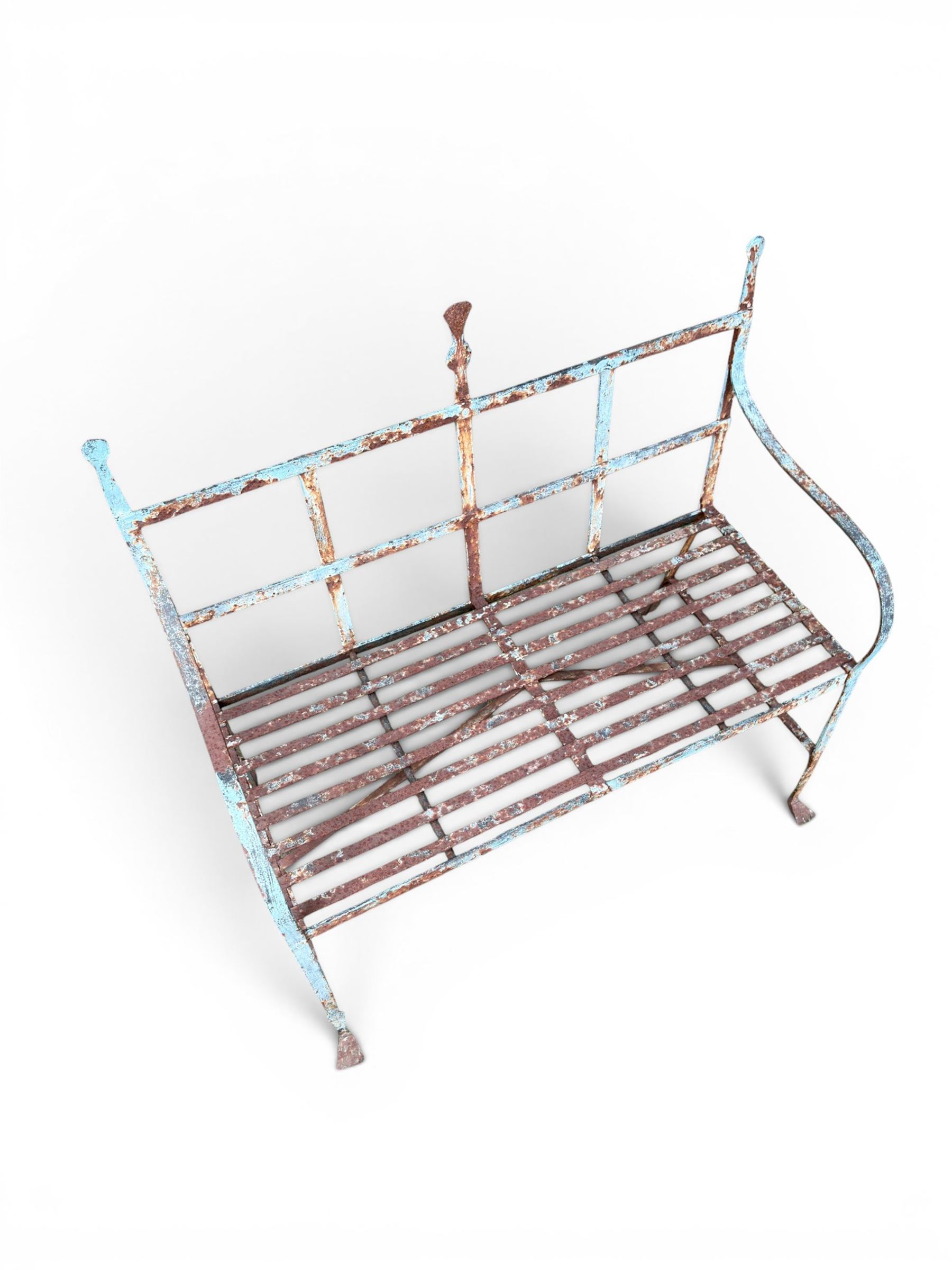 Regency period wrought iron strapwork garden bench, cresting rail with central Scottish thistle motif and flanking pediments, in distressed blue painted finish