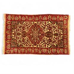 Persian Kerman hand-knotted rug, ivory and crimson ground, central medallion surrounded  b...