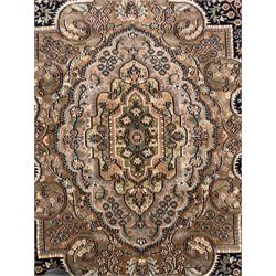 Large Persian indigo ground rug, the busy field decorated with trailing branches and flower heads, peach border decorated with palmettes -