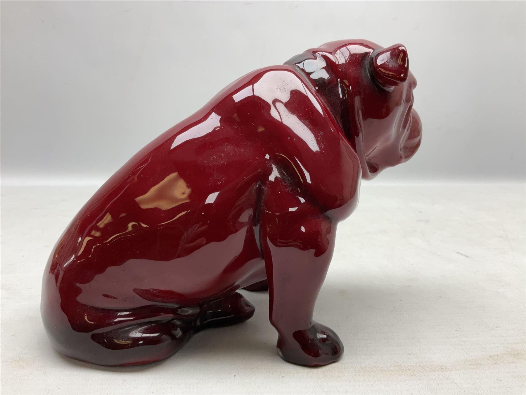Royal Doulton Flambe figure of a Bulldog, modelled seated, model no 135, with printed maker's mark and K and impressed 135 beneath, H13.5cm