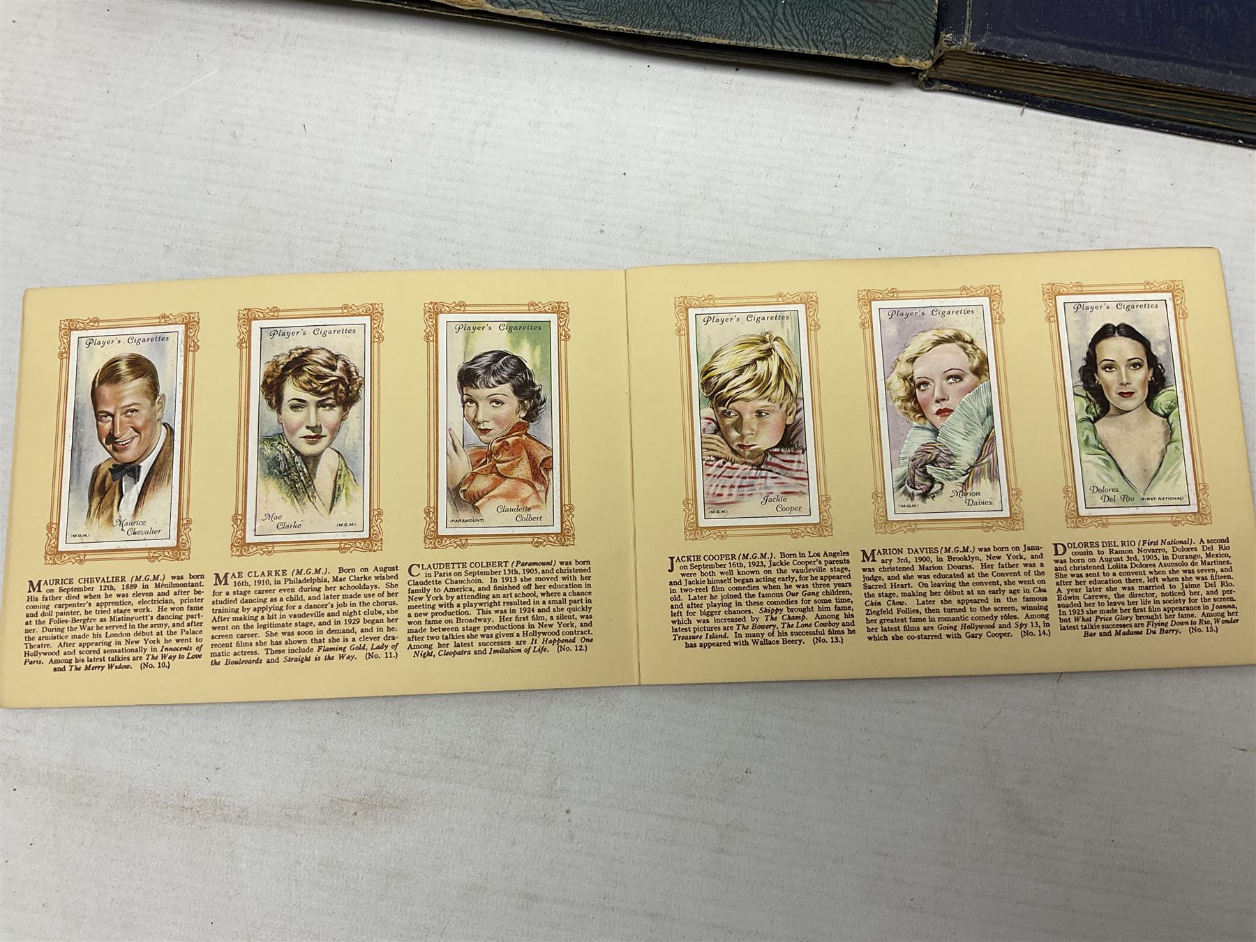 Three albums of cigarette cards including Wills Recruiting Posters, Military Motors and Allied Army Leaders, cricketers etc; another album containing a large quantity of laid-in cigarette cards; and an album of thirty-seven postcards of dogs by Mac (5)