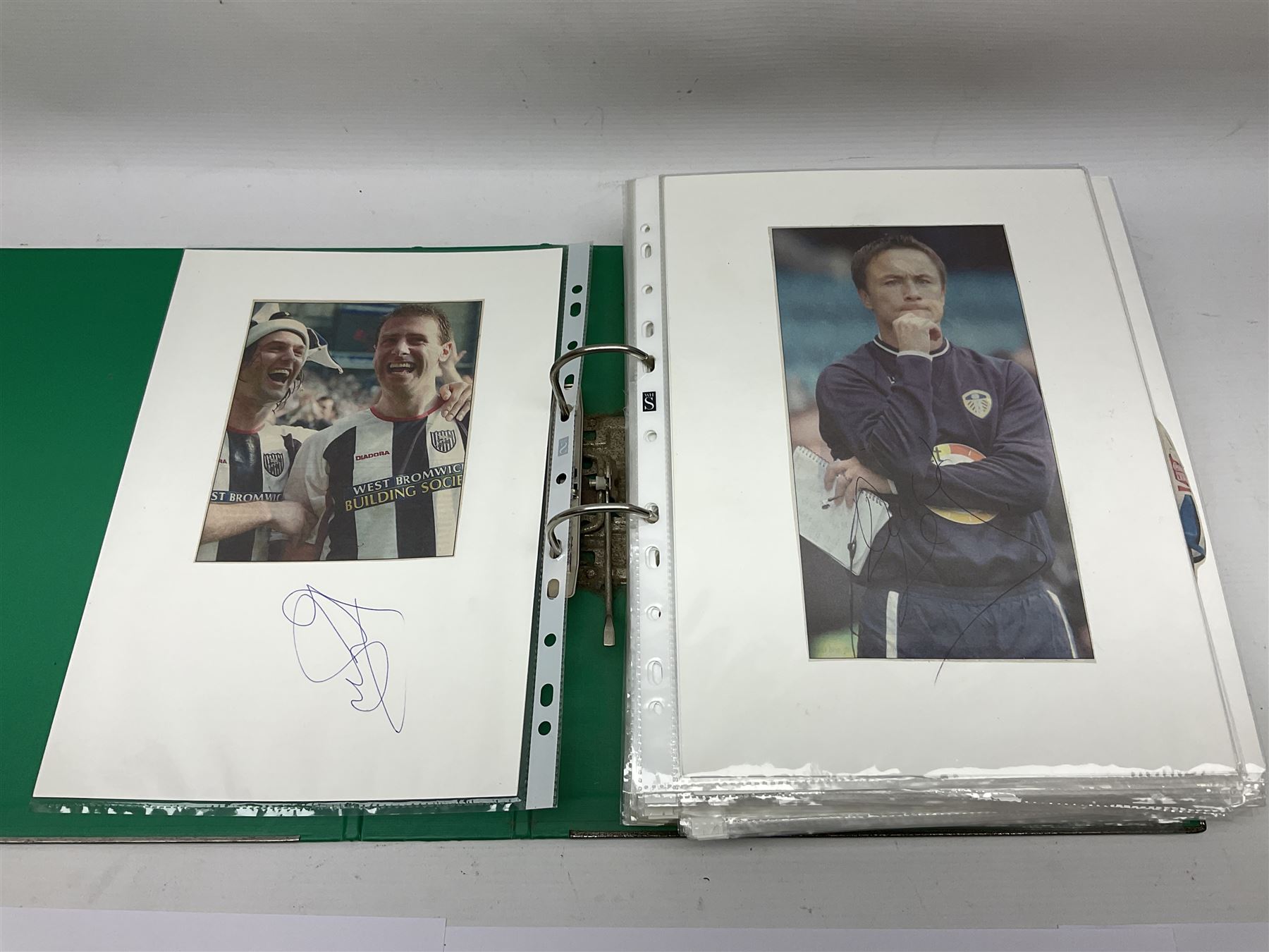 Collection of approximately 200 Leeds United related autographs, predominantly signed newspaper cuttings, contained within ring binder, together with a number of loose examples