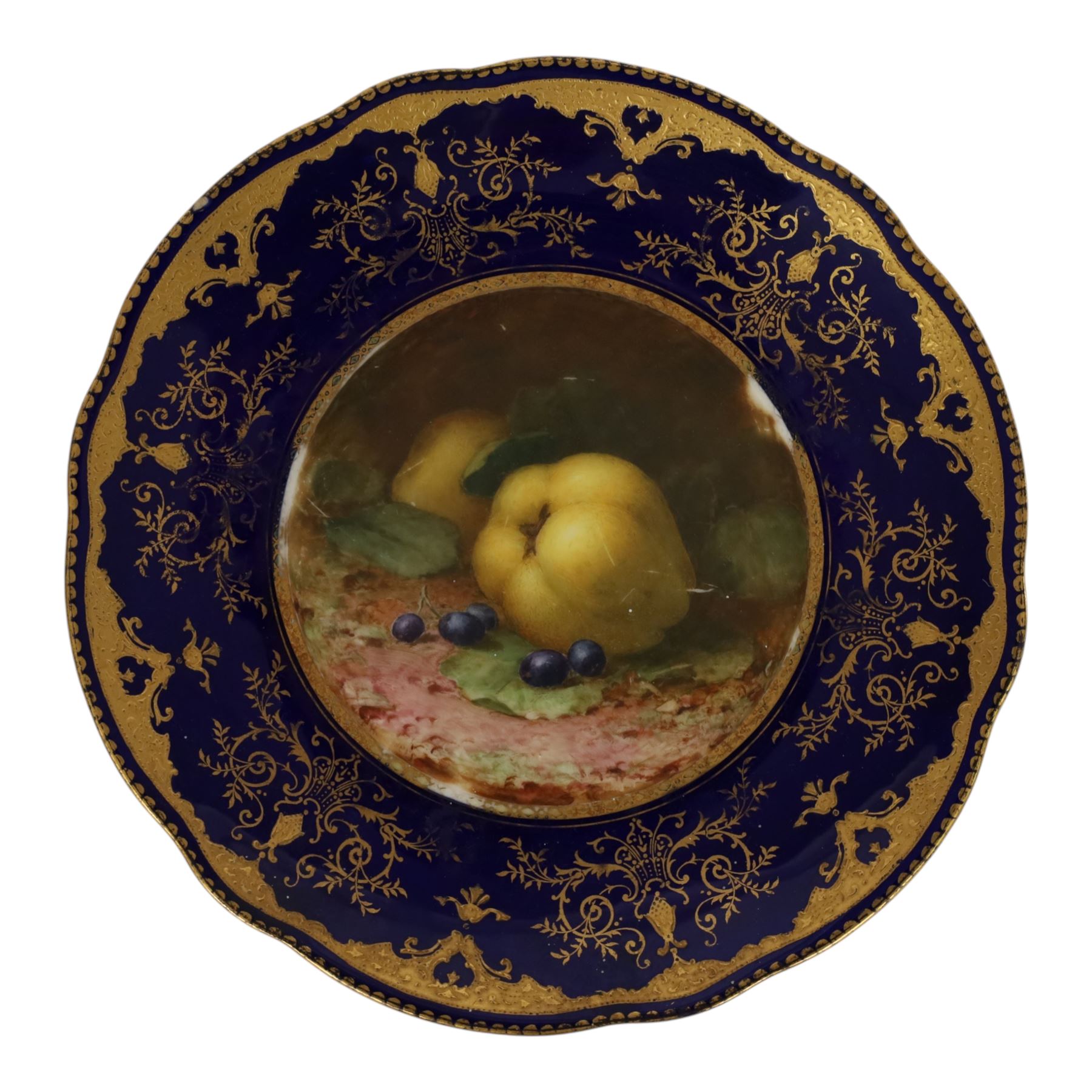 20th century Coalport plate, the centre painted with apples and grapes, signed FH Chivers, with fluted edge, the border decorated with gilt swags and scrolling foliage on a dark blue ground, green printed mark beneath, D23cm 