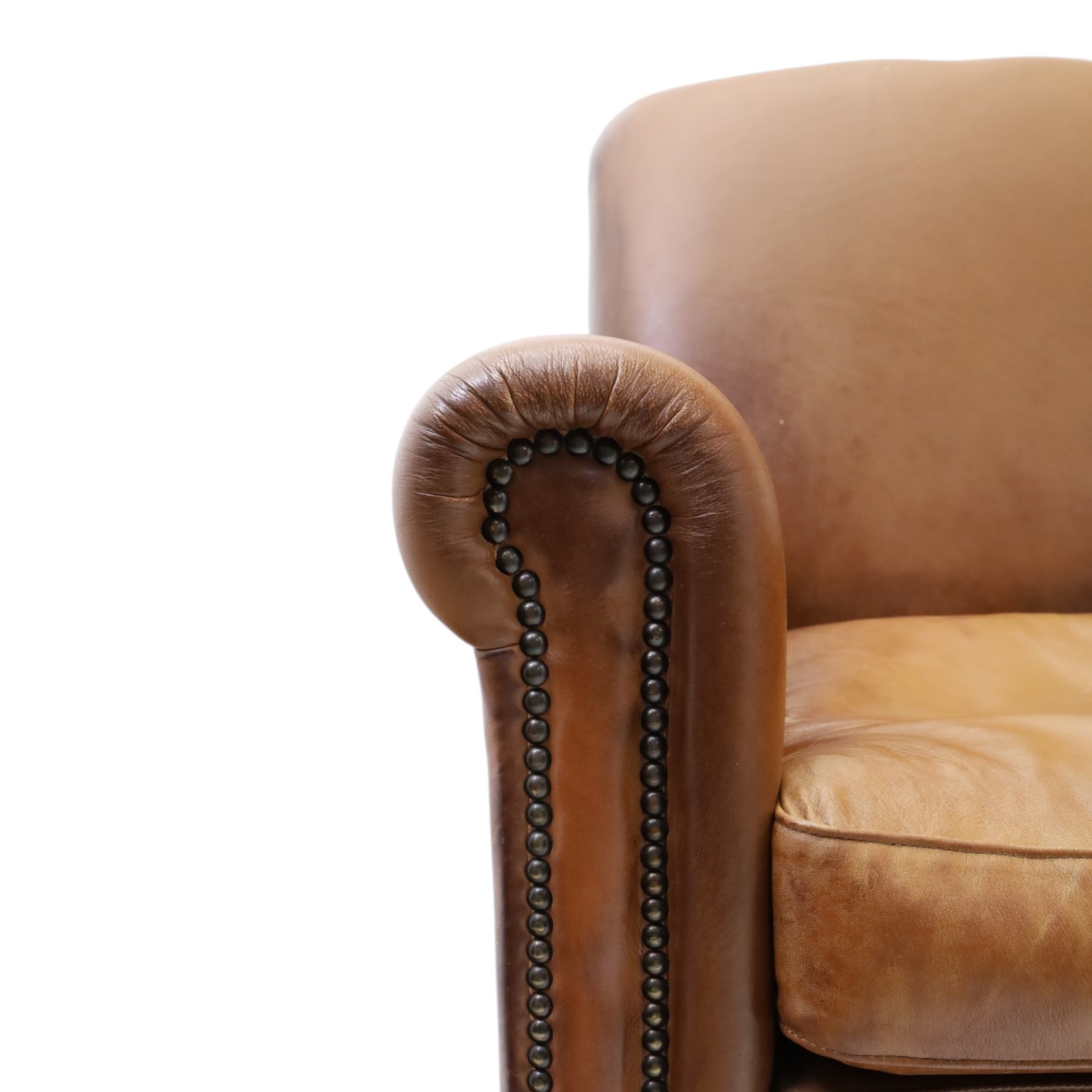 Pair of brown faux leather tub armchairs, scrolled arms with studded detail, turned front feet