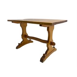 Traditional pine refectory design dining table, raised on shaped end supports with sledge feet, united by waived peg stretcher