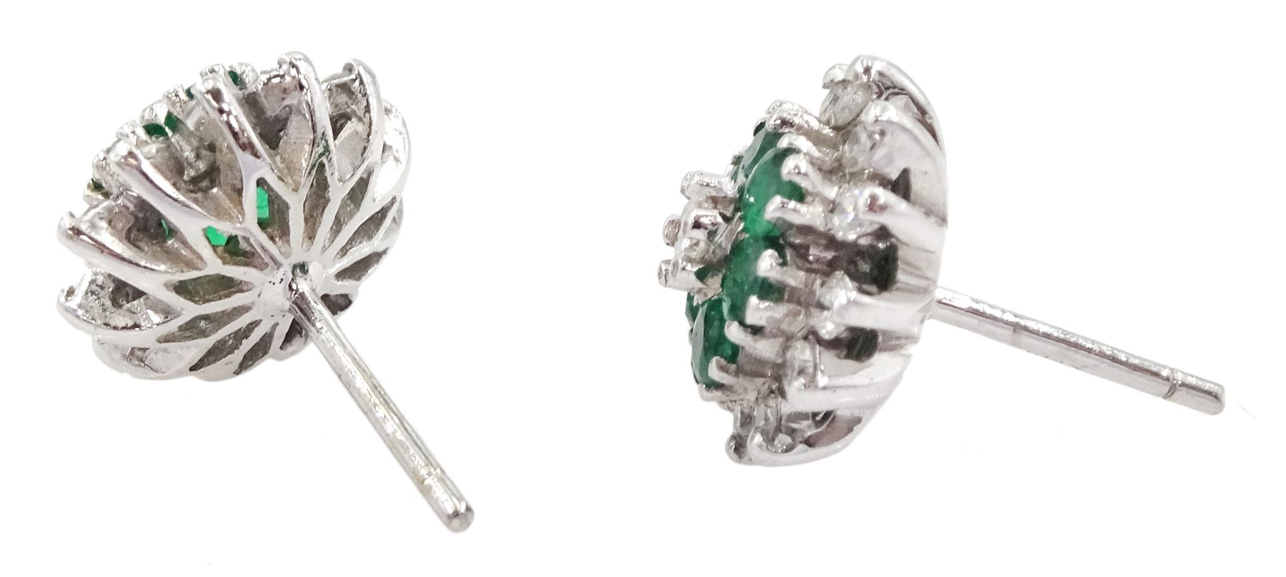 Pair of 18ct white gold emerald and round brilliant cut diamond flower head cluster stud earrings, London 1978 