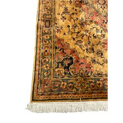 Persian design rug, gold ground and decorated with trailing foliage and plant motifs