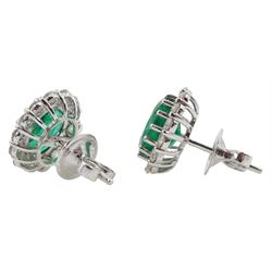Pair of white gold oval emerald and round brilliant cut diamond stud earrings, stamped 18K, total emerald weight approx 3.70 carat, total diamond weight approx 1.05 carat