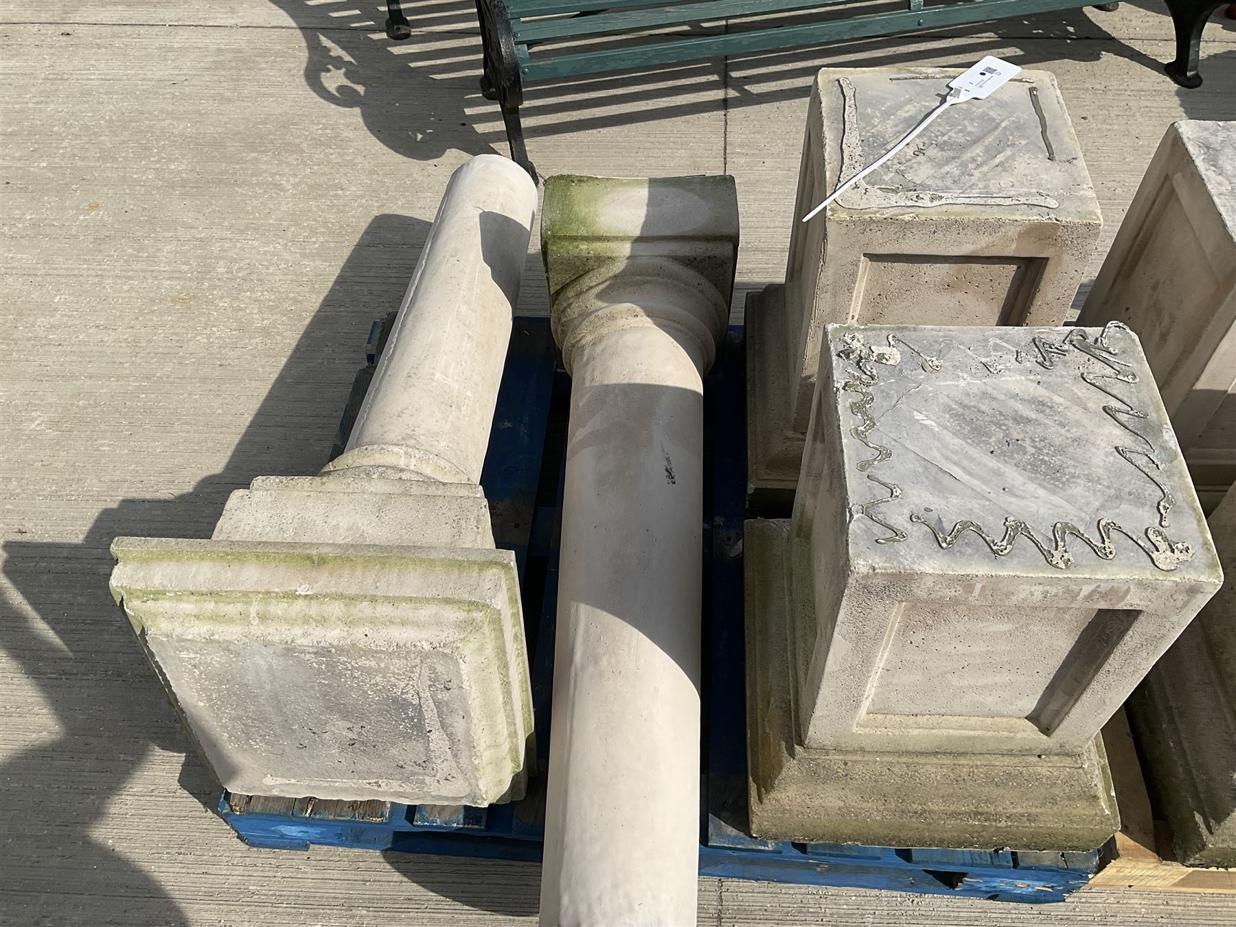 Set of four cast stone architectural columns, tapering form, on square plinth bases
