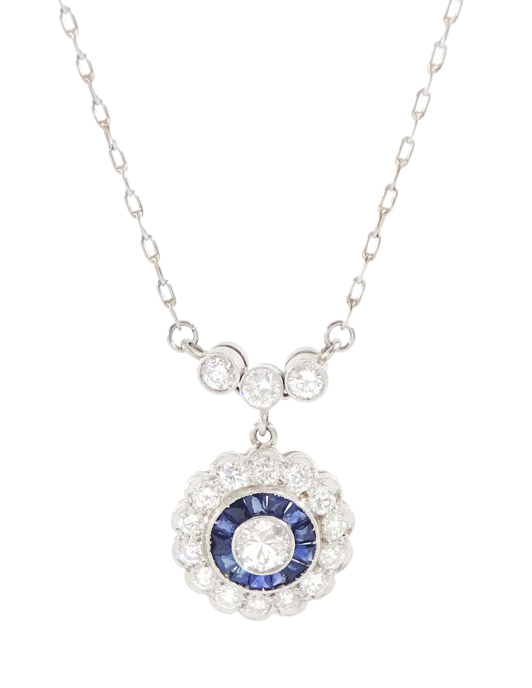 Platinum sapphire and diamond necklace, milgrain set round brilliant cut diamond and calibre cut sapphire cluster, suspending from three round brilliant cut diamonds, to a trace link chain necklace, total diamond weight 0.65 carat, total sapphire weight approx 0.30 carat
