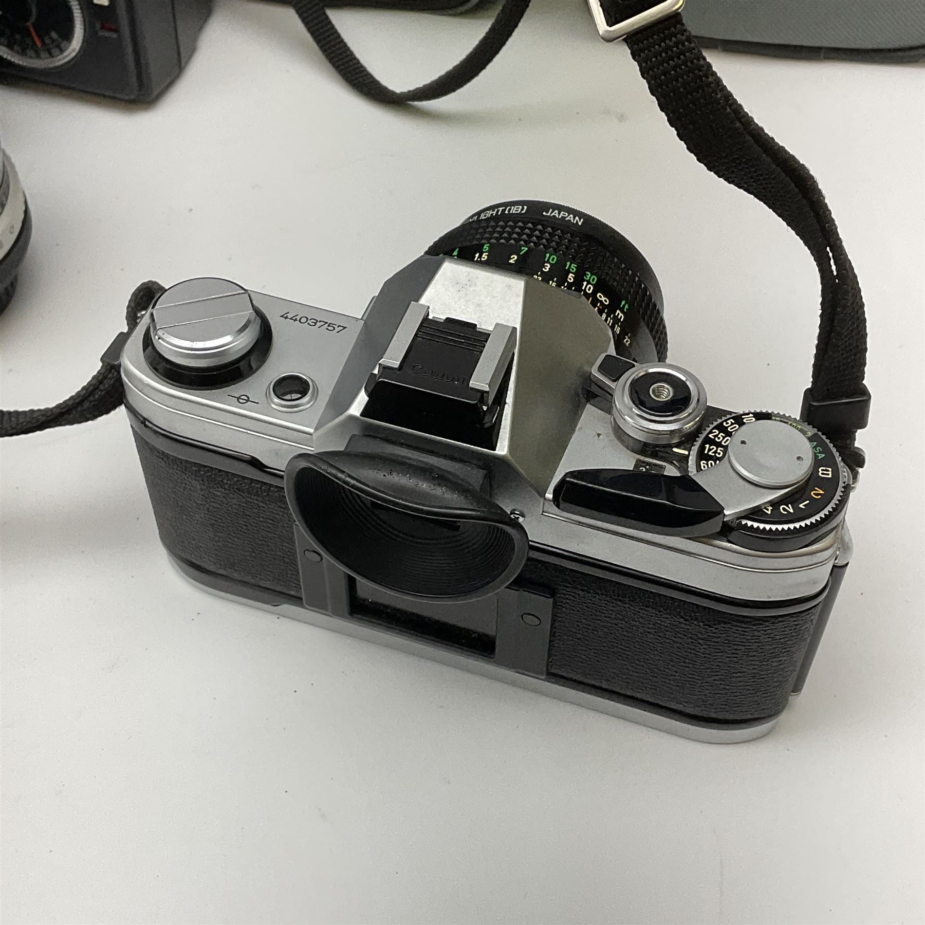 Canon AE1 camera, 'no. 4403757', fitted with Canon 'FD 50mm 1:1.8' lens, Hoya 'HMC Wide-Auto f24mm 1:2.8' lens and various other lenses and camera accessories, housed in a soft carry bag