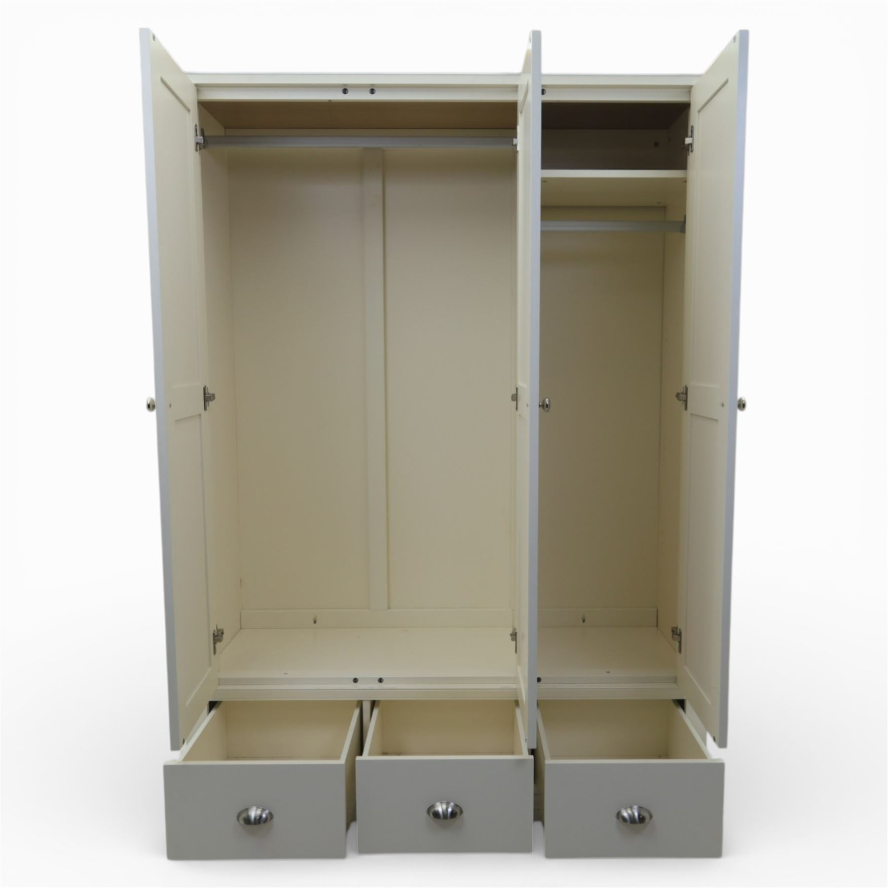 Modern triple wardrobe in white finish with oak moulded top enclosed by three doors with three drawers to base, with metal cup handles raised on bracket feet