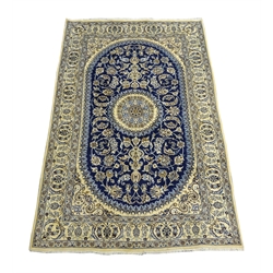  Fine Persian Nain silk and wool ivory rug, circular central medallion sat within blue ground curved rectangular field with frilled edge, scrolled foliage and stylised flower head overall design, 300cm x 195cm  