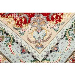 Fine Persian silk inlaid crimson ground Tabriz rug, the shaped field decorated with a central foliate pole medallion filled and surrounded by finely knotted floral motifs and trailing foliage, the cyan guard stripe with bold festoons and palmette motifs