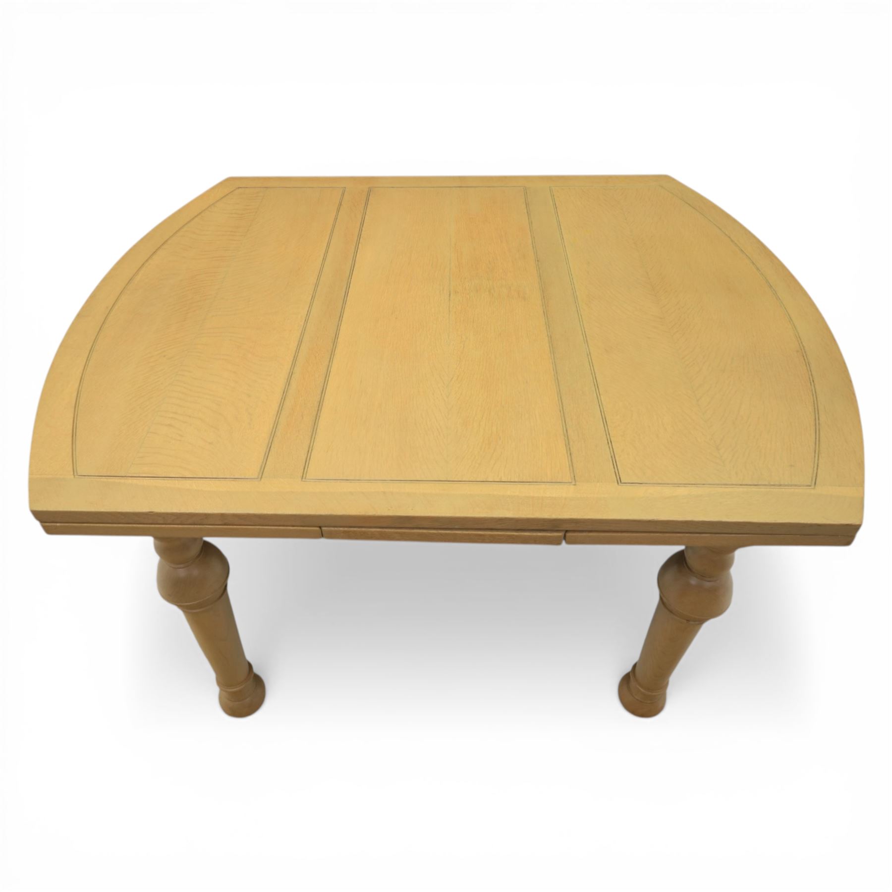 Edwardian light oak extending dining table, oval-ended rectangular top with panelled decoration and double line borders, draw-leaf extension action to 211cm long, on turned supports
