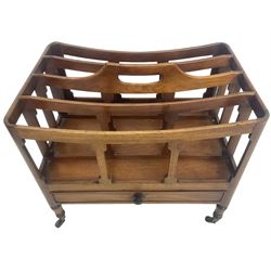 George III mahogany four-division Canterbury, the concave shaped dividers with a central pierced handle, over a single cock-beaded drawer, raised on turned supports terminating in brass cups and castors