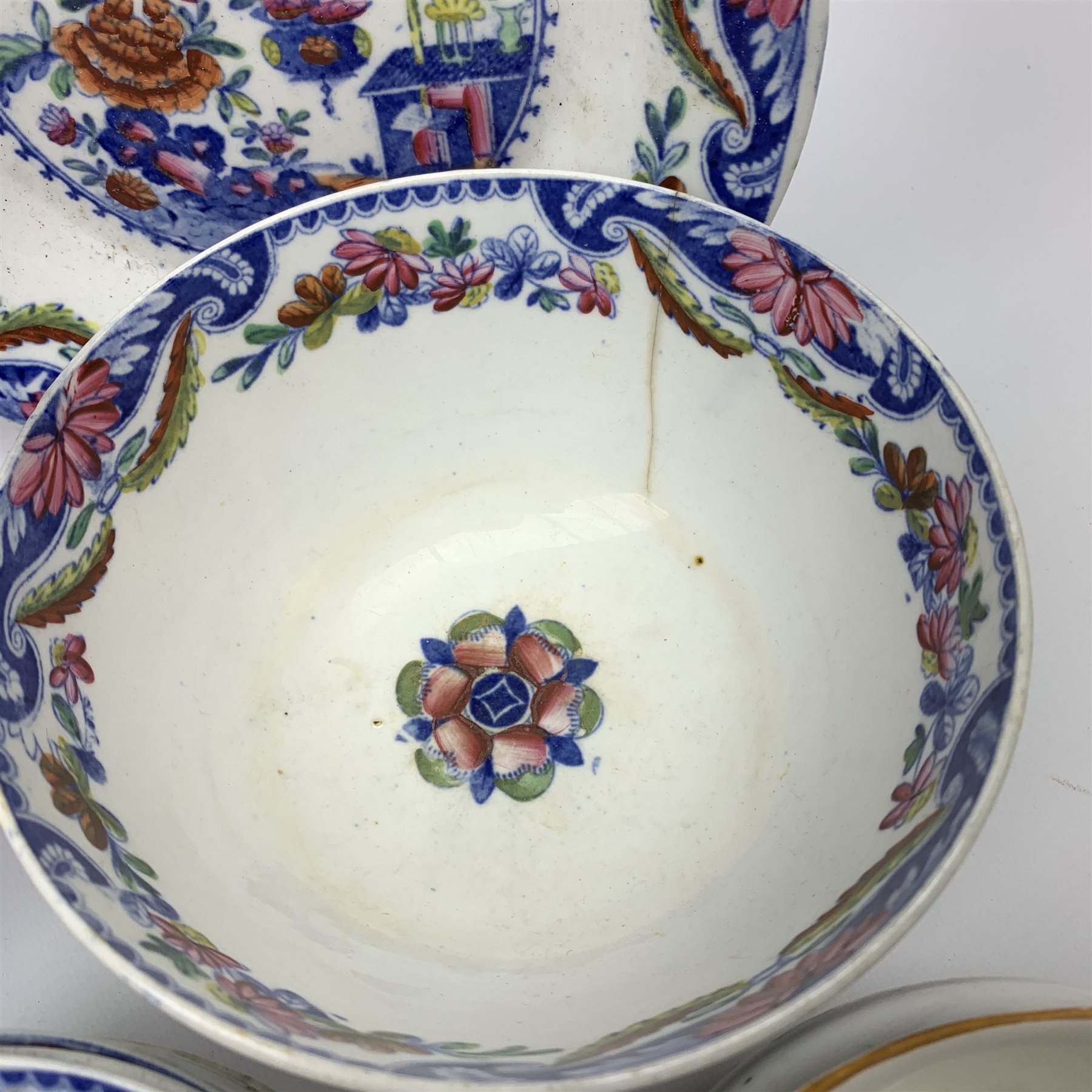 Early 19th century Spode Dolls House pattern tea wares, comprising teapot, twin handled sucrier and cover, milk jug, five teacups, two coffee cans, six saucers, stand, and shallow dish, decorated with a house and flowers in blue and orange, a number of pieces marked with pattern number 488, together with a quantity of other 19th century tea wares. 