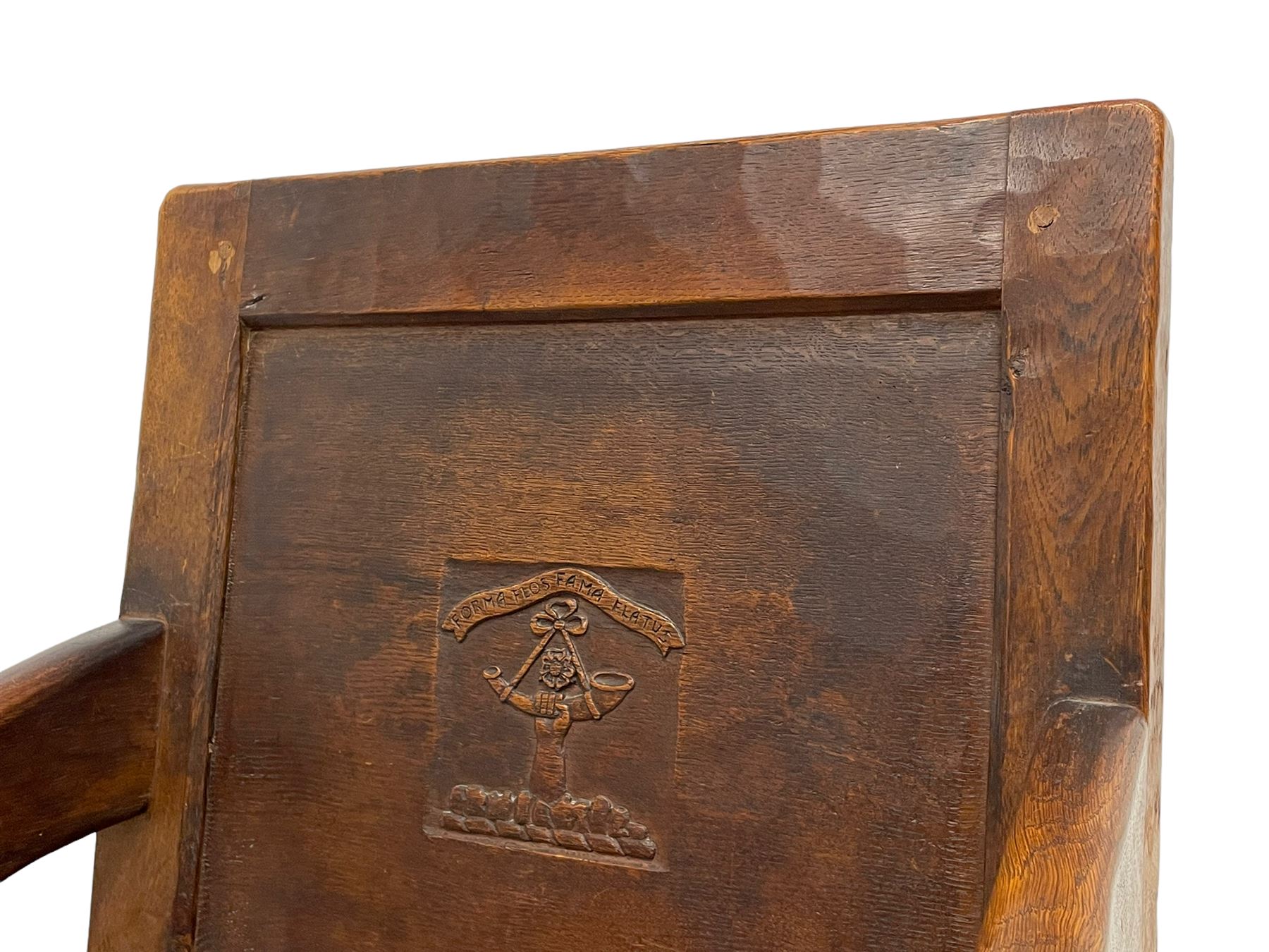 Mouseman - circa. 1930s set of six (4+2) oak dining chairs, panelled back carved with the Bagshawe family crest, the moto 'Forma Flos Fama Flatus' over an arm grasping a bugle-horn with ribbon tie and Yorkshire rose motif, adzed frame, leather lattice strap seat, on octagonal supports united by stretchers, two carvers and four side chairs, each carved with mouse signature, by Robert Thompson of Kilburn 

Provenance: Owned since manufacture by the Bagshawe family, descendants of the Staithes Group Artist Joseph Richard Bagshawe RBA (1870-1909).