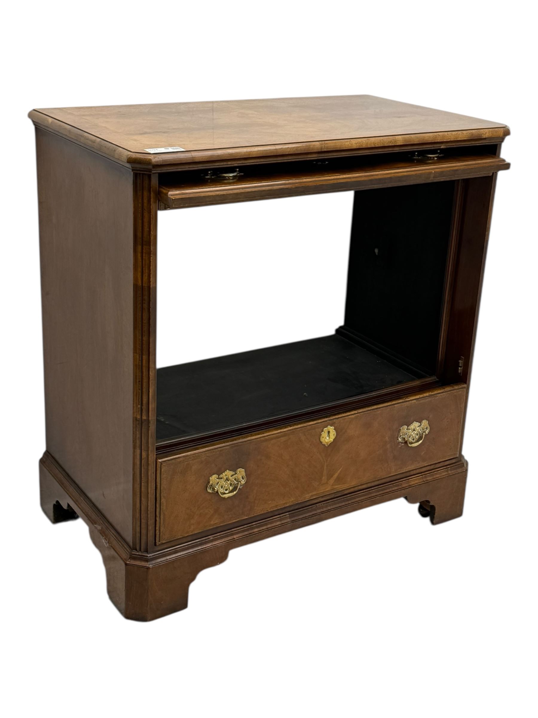 Late 20th century walnut veneered television chest in Georgian style, rectangular top over simulated drawer front with central marquetry star inlay, opening to a shelved TV compartment, lower section fitted with one long drawer, brass handles and ogee bracket feet