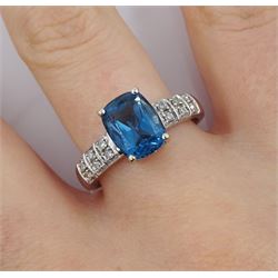 9ct white gold London blue topaz ring, with diamond set shoulders, hallmarked 