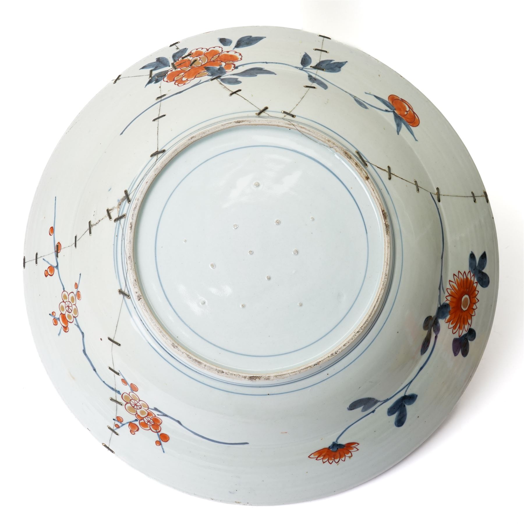 Japanese 18th century Edo period Imari porcelain charger, painted with a central peony in vase within a border of kiku and spotted shi-shi, D54cm 
