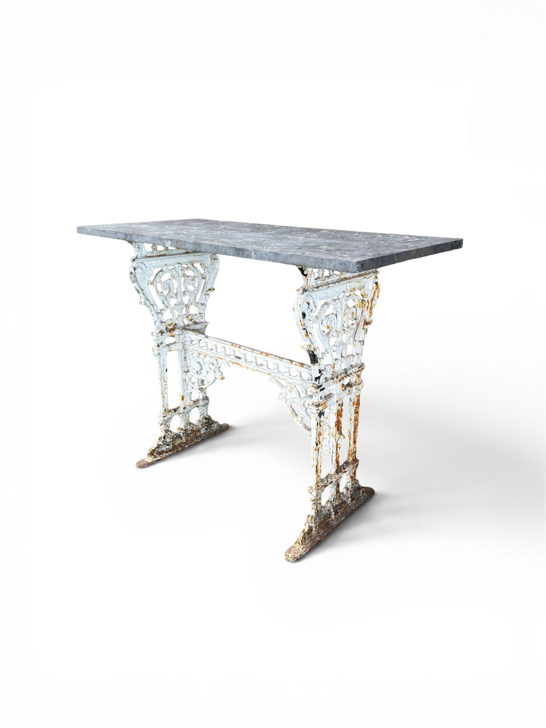Victorian ornate cast iron garden table, trefoil base with central enclosed column, circular top with later marble, with registration mark