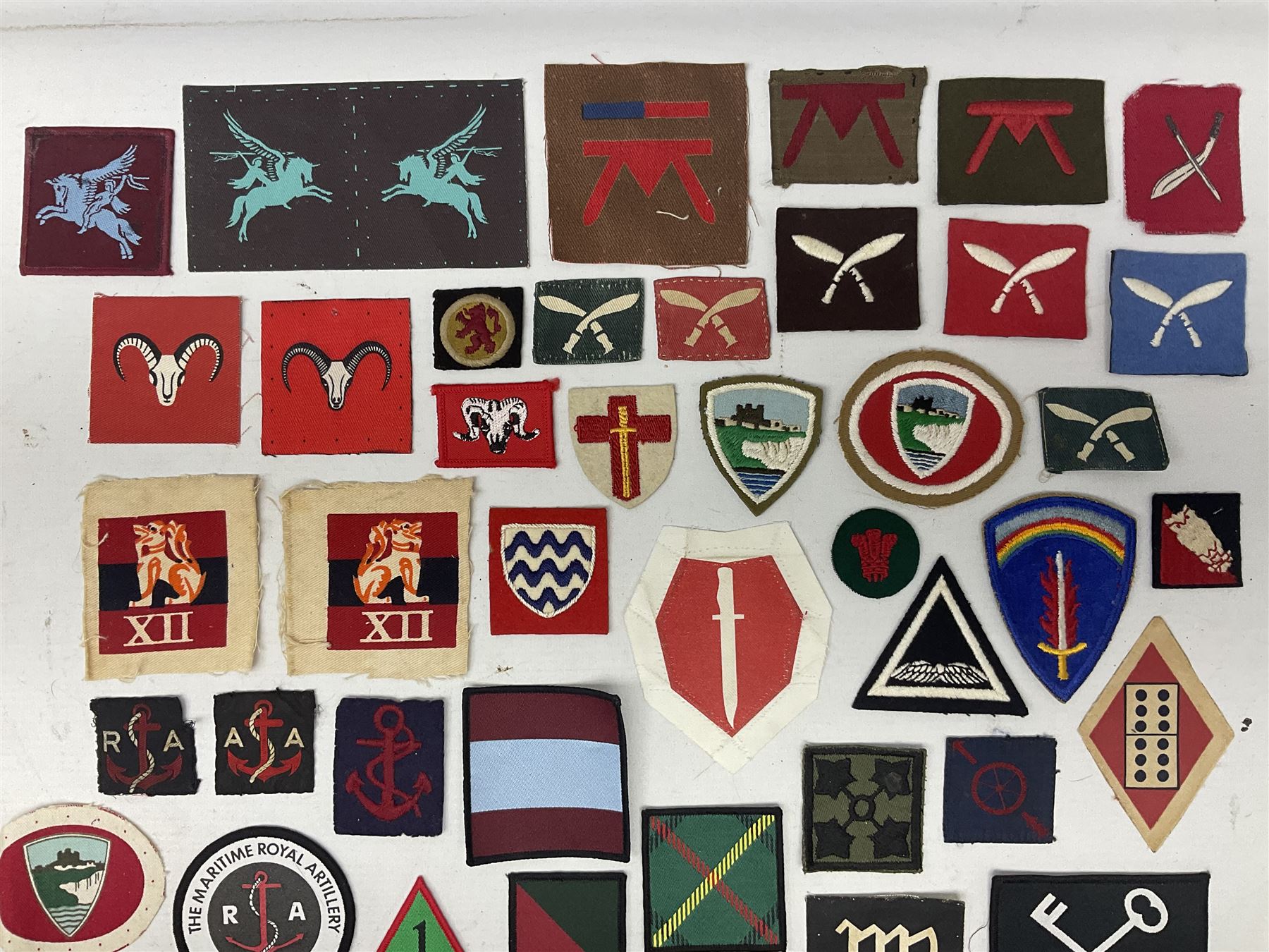 Approximately onehundred printed and embroidered cloth badges