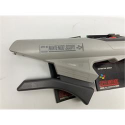 Two Super Nintendo Entertainment System (PAL) controllers, accessories and games. Super NES Game Commander with original box and instruction booklet, Super NES Nintendo Scope (1992) transmitter gun, receiver, Super NES Nintendo Scope 6 game with original instruction booklets. Further games to include ‘The Legend of Zelda a Link to the Past’, ‘Super Mario World’, ‘Super Mario Kart’, ‘The Lawnmower Man’, and ‘Exhaust Heat’, all with original instruction booklets. ‘PowerMonger’ and Disney’s ‘Aladdin’ game cartridges only 