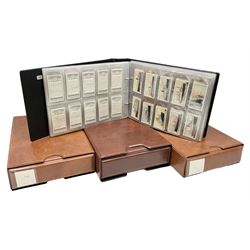 Four modern loose leaf albums containing a large quantity of cigarette cards by Players, Wills, Lambert & Butler and Gallahers including Recruiting Posters, Military Motors, shipping, aviation, military and medals, cricketers and other sporting, horsemanship, royalty etc; three in slip cases (4)