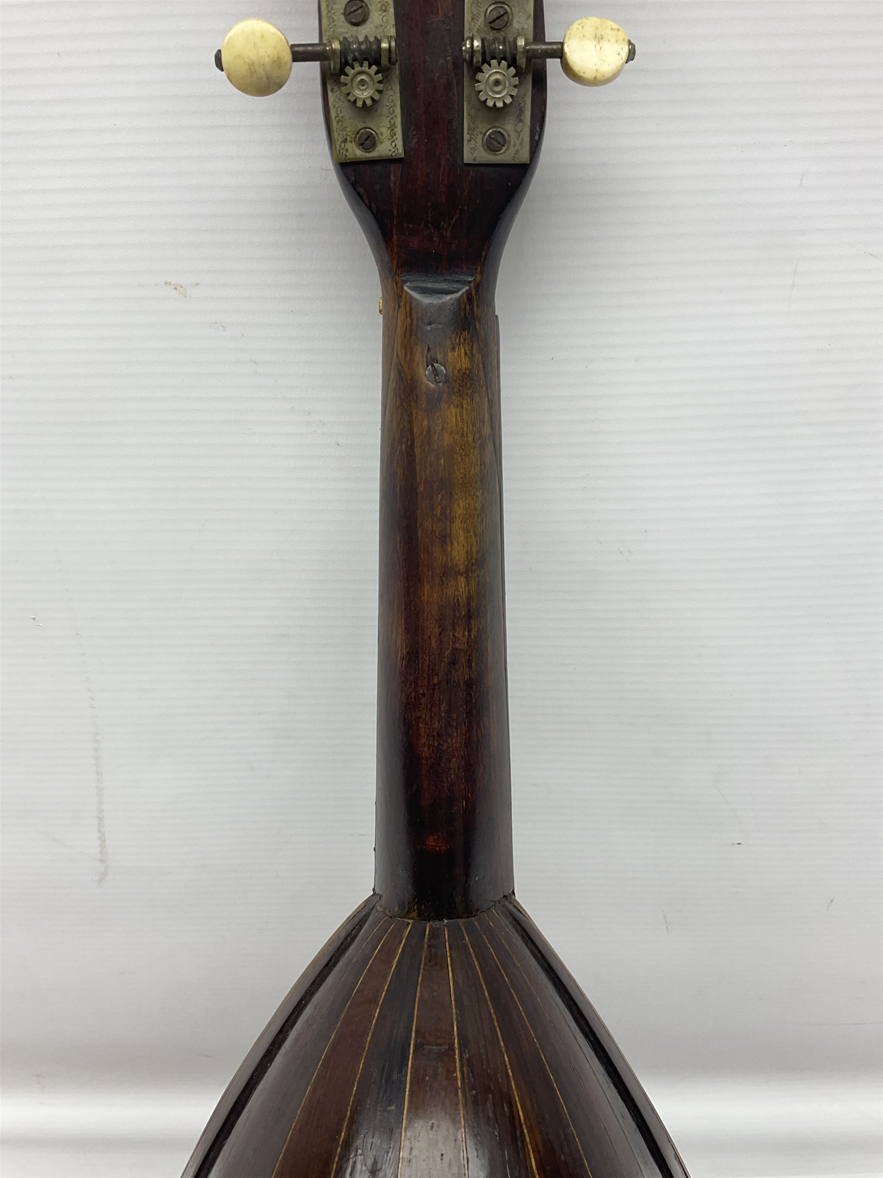 Late 19th century Italian lute back mandolin with segmented bowl back, bears label Gennaro Maglioni Napoli L61cm; in ebonised wooden case; together with another similar damaged Italian lute back mandolin for restoration or spares (2)