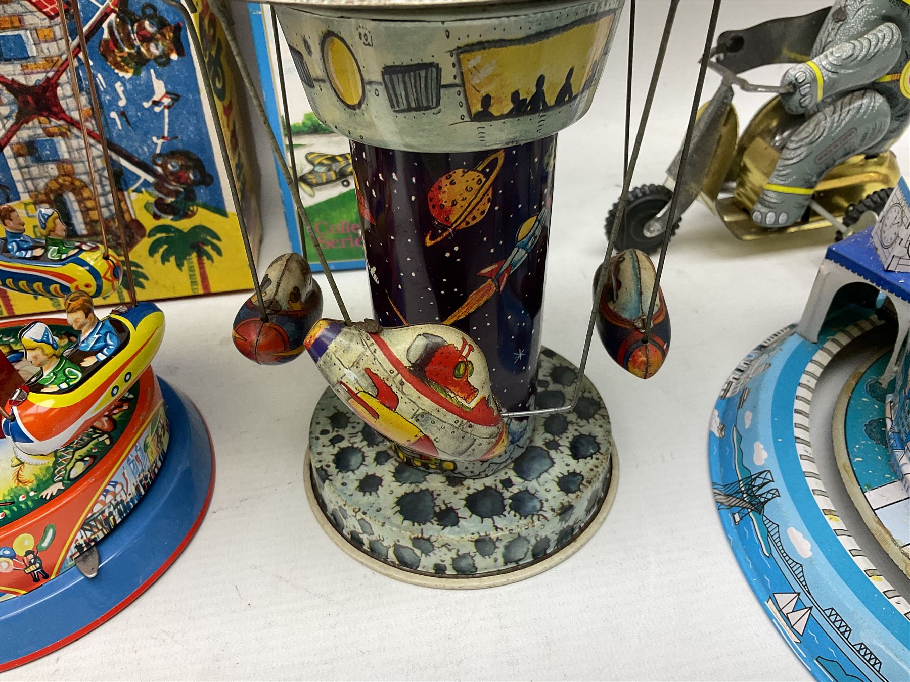 Mid 20th century and later tin plate clockwork toys, to include merry-go-rounds, spaceship carousel, walking robot, Schylling airport control tower, monkey riding horse, astronaut space station etc, including German and Japanese examples, some with boxes (12)