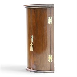 Small Georgian mahogany cylindrical hanging corner cabinet, projecting cornice with dentil carving, brass H hinges and escutcheons