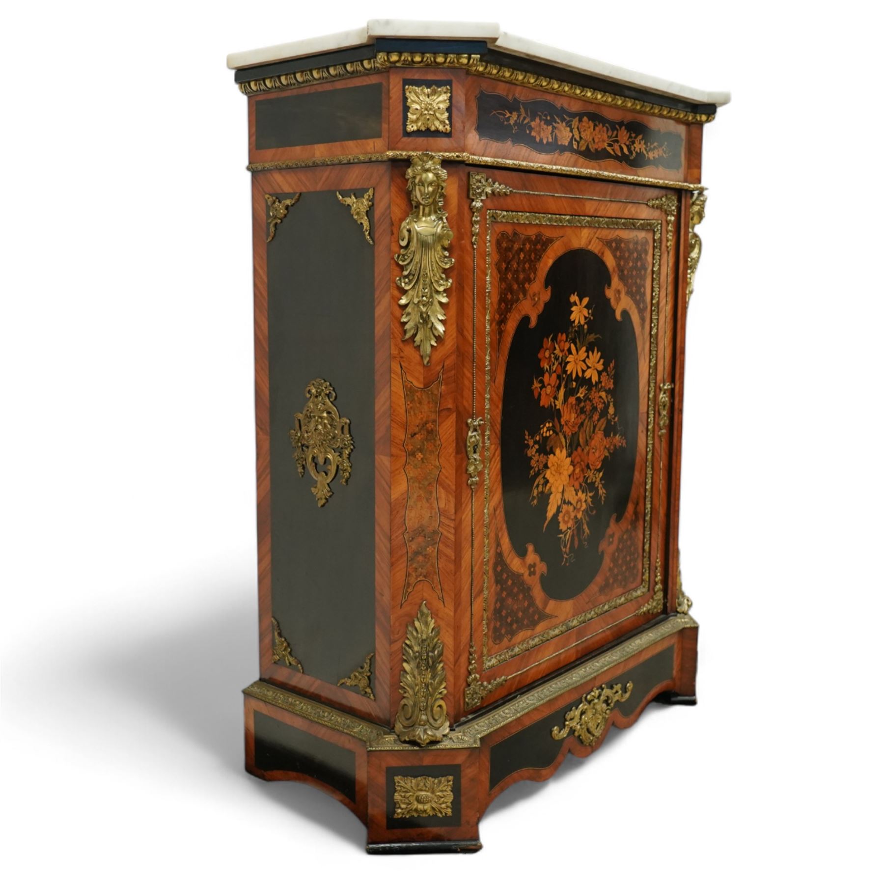 Late Victorian floral marquetry and ormolu mounted side cabinet, with white marble top above a frieze of floral inlay, single cupboard door revealing a shelved interior, with central floral bouquet panel within gilt-bronze border, flanked by gilt metal mounts of female masks and scrolls, on shaped plinth base
