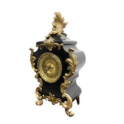 Ansonia - American late 19th century steel cased 8-day mantle clock in a Rococo case with decorative brass mounts, brass dial with Arabic numerals, steel hands and a repousse dial centre, twin train striking movement sounding the hours and half hours on a gong. with pendulum and key.