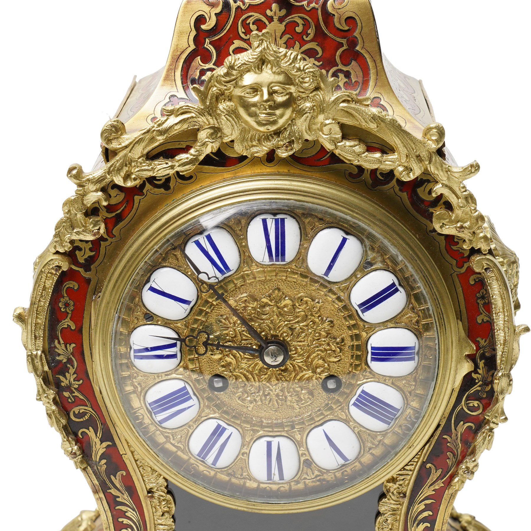 Rollin à Paris - 19th century French Louis XV style ormolu-mounted red tortoiseshell and brass Boulle-work mantel clock, surmounted by a seated musical putto above a waisted case applied with mask, rocaille, foliate and dolphin mounts, the gilt dial with white enamel Roman numeral cartouches, twin-train movement striking on a bell, signed and numbered 480, on four scrolling foliate feet