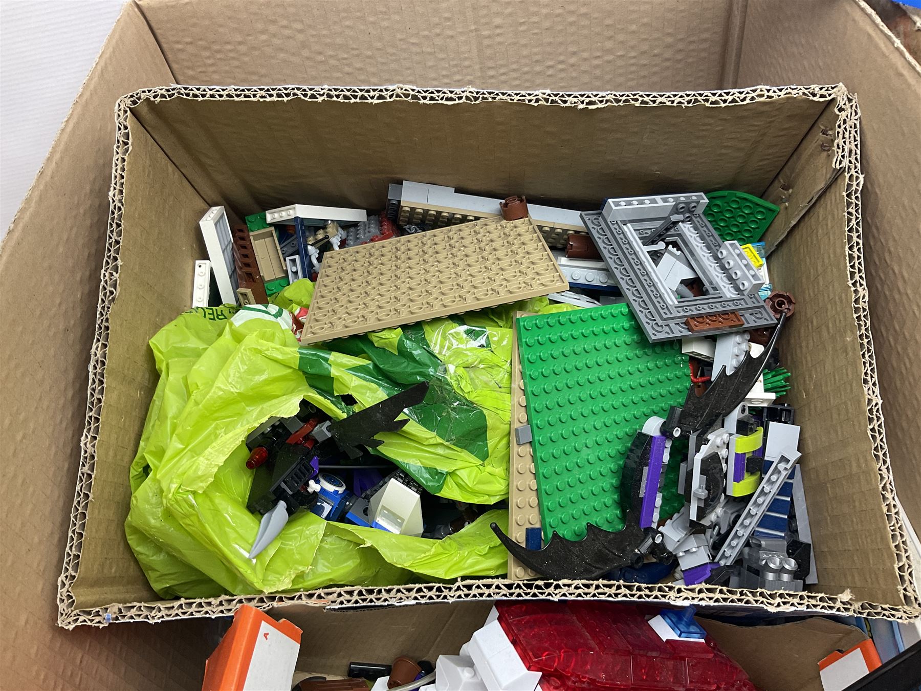 Very large collection of Lego, predominantly loose but some part constructed models, including Lego City, Lego Technic, Chima, Arctic 5, train set, mobile crane etc; together with numerous instruction booklets and some empty boxes; contained in two large cardboard boxes with gross weight of over 24kgs