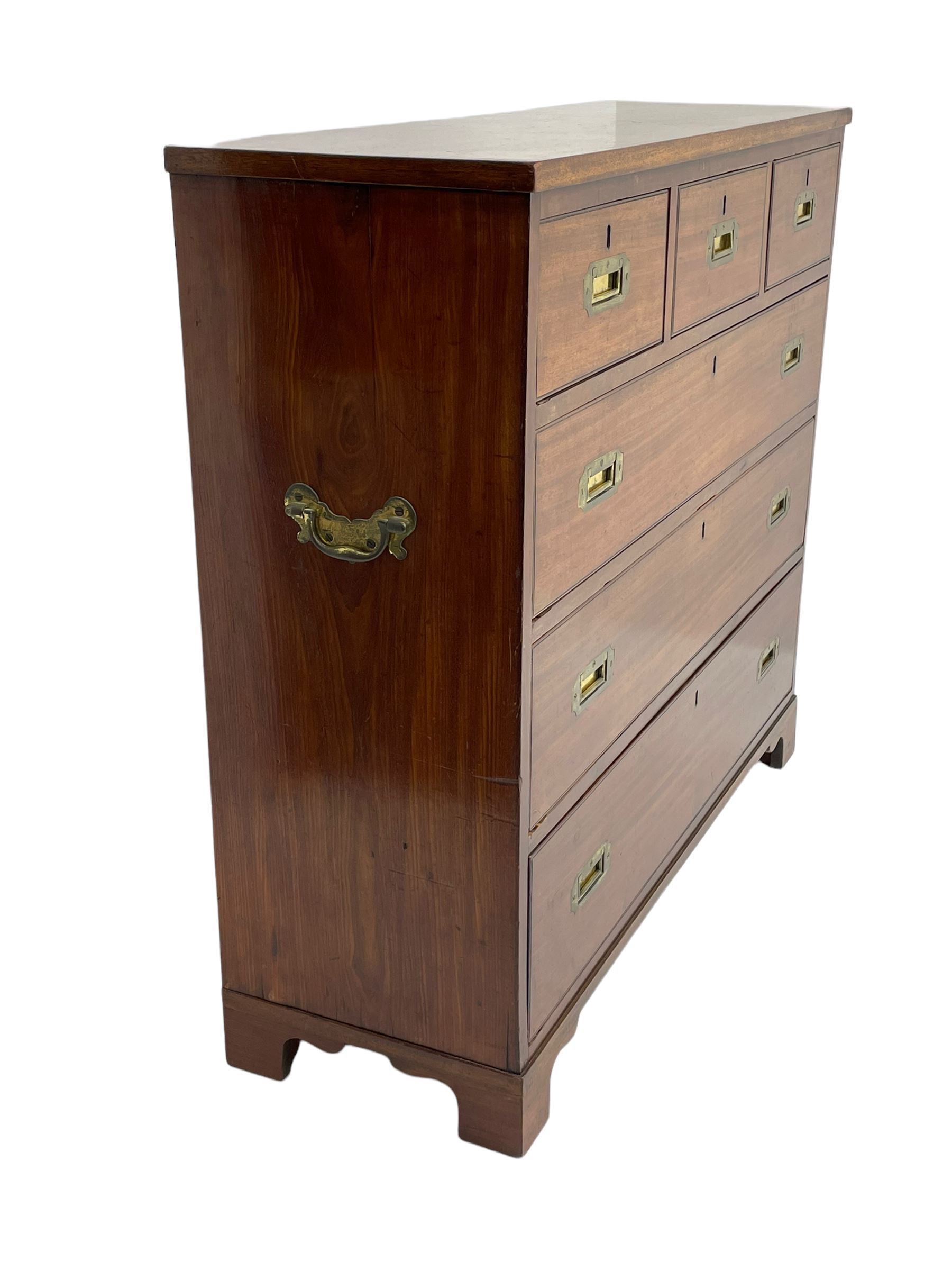 Georgian military type campaign chest, narrow rectangular top over three short and three long drawers, recessed brass handles, on bracket feet